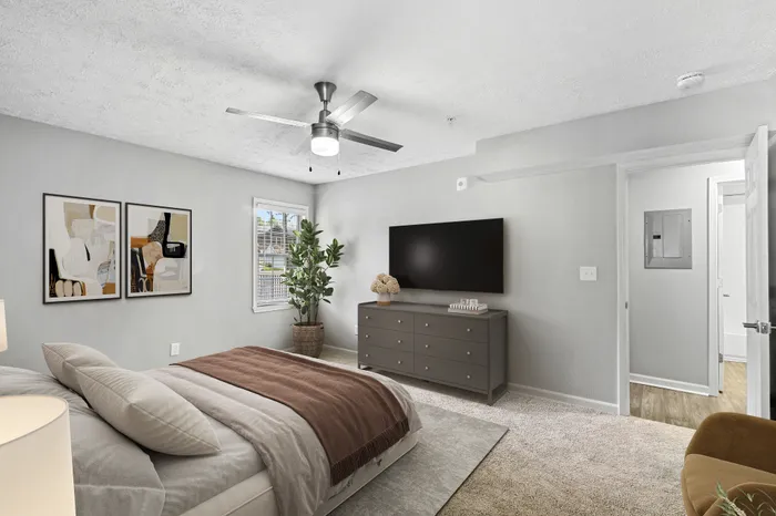 Virtual staging of bedroom with large bed and ceiling fan