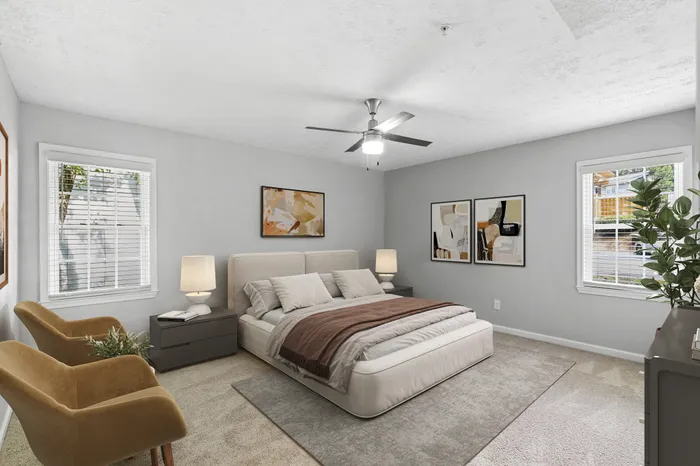 Carpeted bedroom with bed and ceiling fan