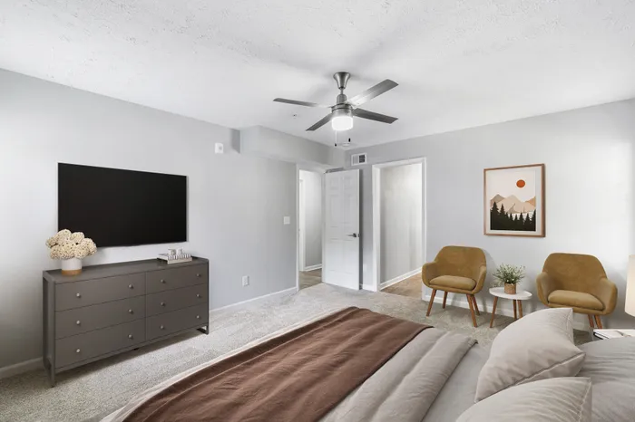 Virtual staging of bedroom with large bed and ceiling fan