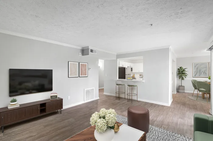 Virtual staging of living room, kitchen, and dining room with hardwood floors