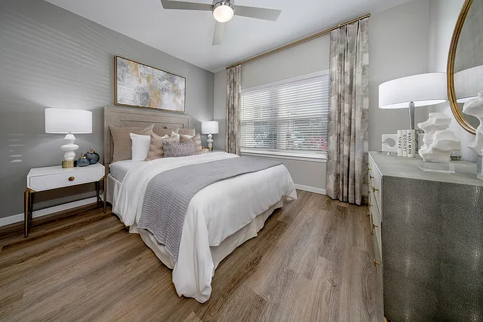 Renovated bedroom with wood style flooring and a bed