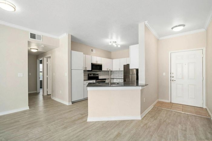 Contemporary apartment featuring a stylish kitchen with modern appliances, open layout, and sleek flooring.
