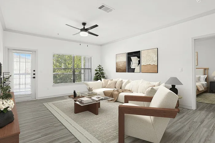Bright, modern living room with cozy sofas, chic artwork, and natural light streaming through large windows.