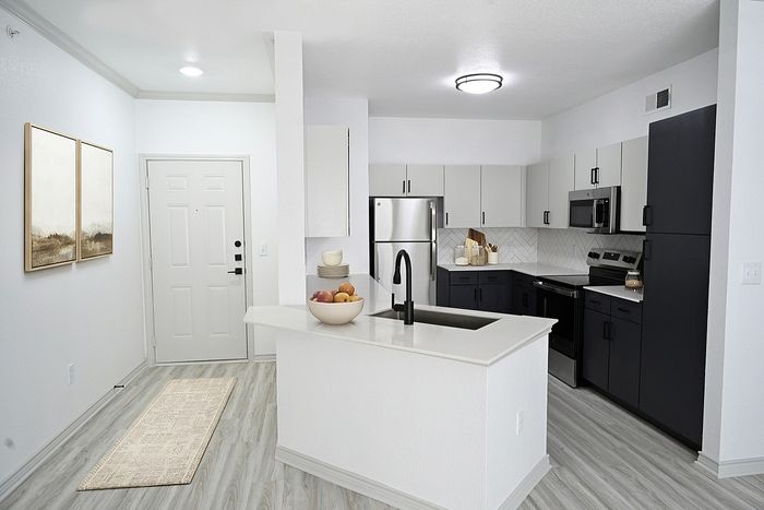 Modern kitchen with sleek cabinetry, stainless steel appliances, and elegant countertops, offering a stylish and functional cooking space.