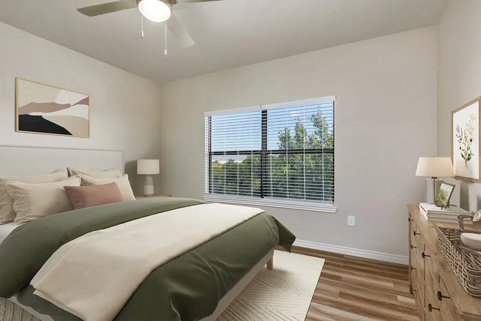 Inviting bedroom with a cozy double bed, modern decor, and large window offering scenic views, ideal for relaxation.