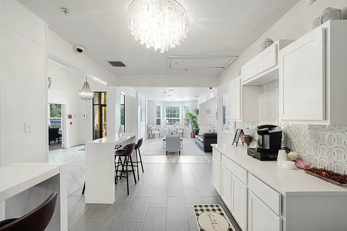 Luxurious open-layout apartment showcasing a sleek kitchen, elegant lighting, and a bright, inviting living area.