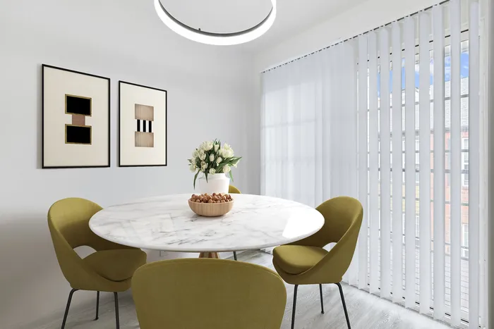 Round dining table with green chairs, wall art, and glass sliding patio.