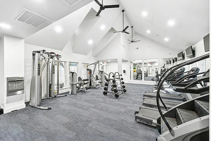 Fitness Center with gym equipment and high ceiling fans.