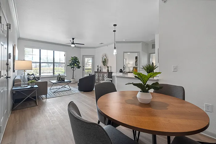 Bright and modern living area featuring stylish decor, an elegant dining nook, and large windows offering natural light.
