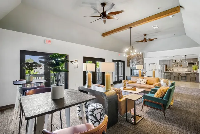 Luxurious resident clubroom with modern decor, stylish seating area, and elegant kitchen in the background, perfect for entertaining.