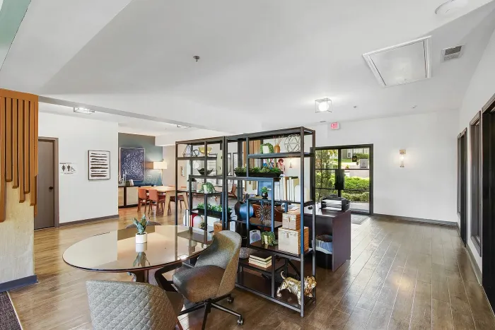 Contemporary leasing office with elegant furniture, large windows, and inviting decor, providing a professional yet warm atmosphere.