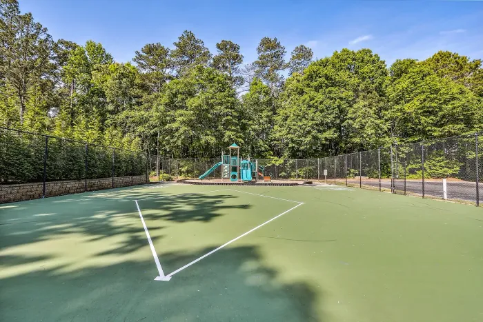 Inviting sports court nestled among lush greenery, offering a perfect blend of recreation and nature.