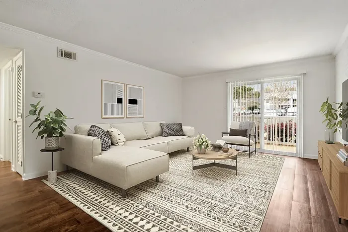 Bright, spacious living room with elegant decor and large glass doors opening to a garden view, perfect for relaxation and entertaining.