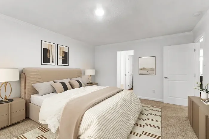 Elegant bedroom with a king-sized bed, stylish decor, and soft lighting, exuding cozy luxury.