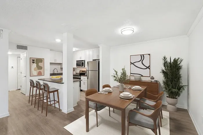 Contemporary apartment dining area with elegant wooden furniture, open kitchen, and modern decor for sophisticated living.