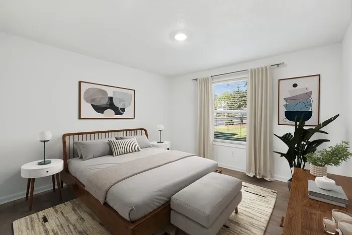 Bright and airy bedroom with a modern design, featuring a cozy bed, stylish decor, and a large window with a scenic view.