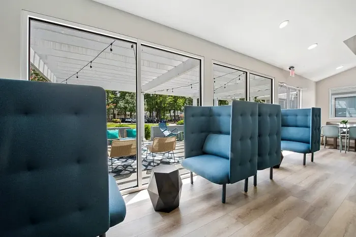 Interior resident lounge with oversized blue chairs.