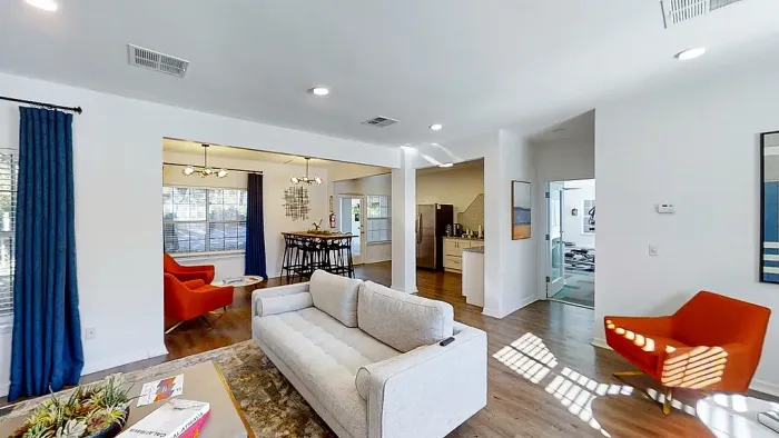 Clubhouse interior with open-concept layout, modern kitchen, dining space, and lounge seating.