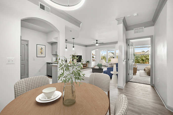 Bright and modern open-concept apartment with elegant dining area, cozy living room, and spacious bedroom featuring ample natural light and stylish decor.