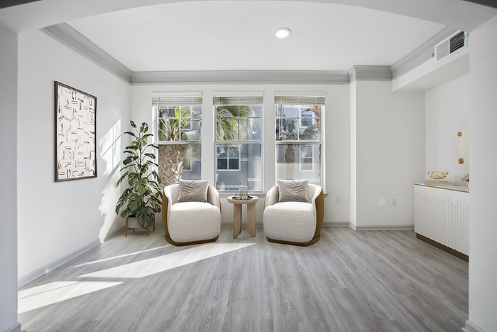 Bright and inviting living area with plush seating, elegant decor, and large windows overlooking scenic views.