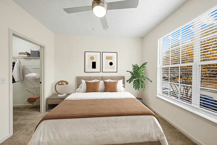 Bright and airy bedroom with cozy double bed, modern decor, large window offering natural light, and a spacious walk-in closet.