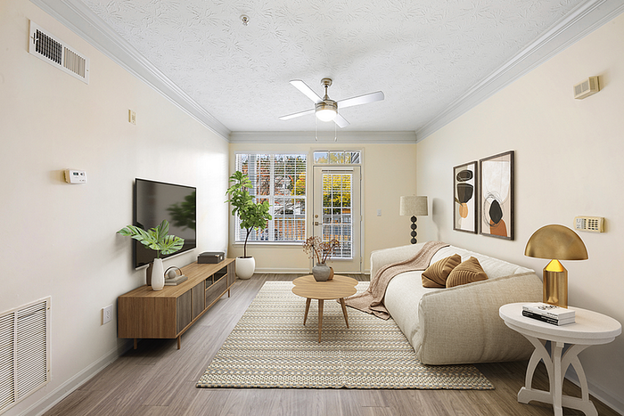 Bright and airy living room with modern decor, featuring a cozy beige sofa, stylish wooden media console, and lush indoor plants.