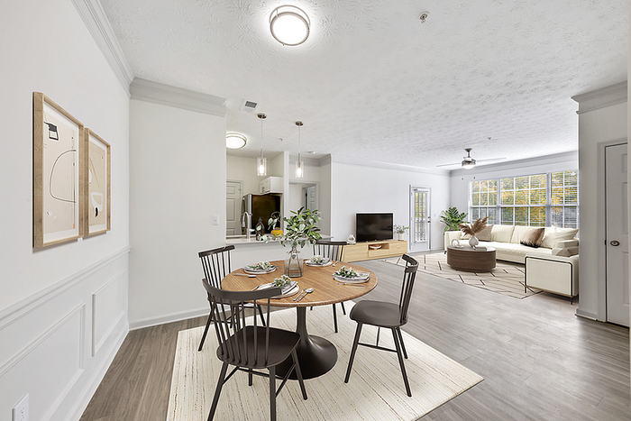 Bright and airy open-concept living and dining area with elegant wood flooring, contemporary furnishings, and abundant natural light.