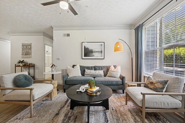Inviting living room with modern furniture, large windows, and stylish decor creating a cozy atmosphere.