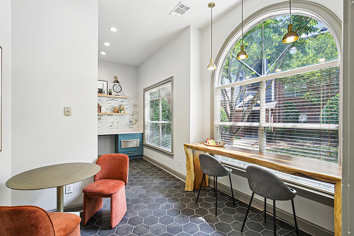 Bright and modern reading nook with arched windows, elegant lighting, and stylish seating, perfect for relaxation.