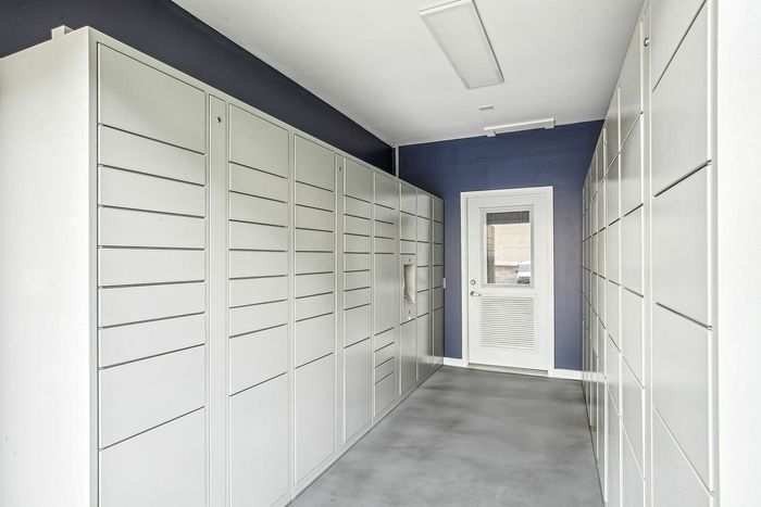 Modern package locker with sleek, organized parcel lockers and a secure door access.