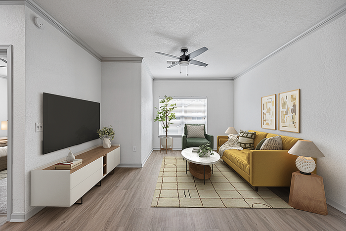 Modern living room with a stylish yellow sofa, elegant coffee table, and large flat-screen TV showcasing a warm and inviting atmosphere.