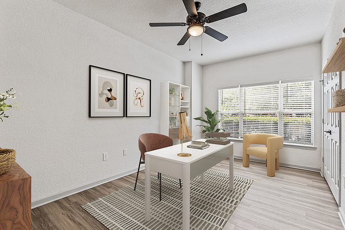Chic home office with modern decor, featuring a stylish desk, elegant artwork, and large windows offering plenty of natural light.
