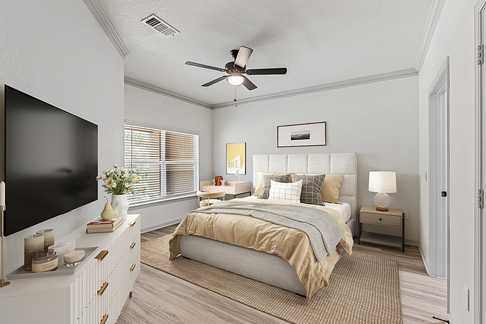 Bright and spacious bedroom with a plush bed, stylish dresser with decor, and natural light streaming through large windows.