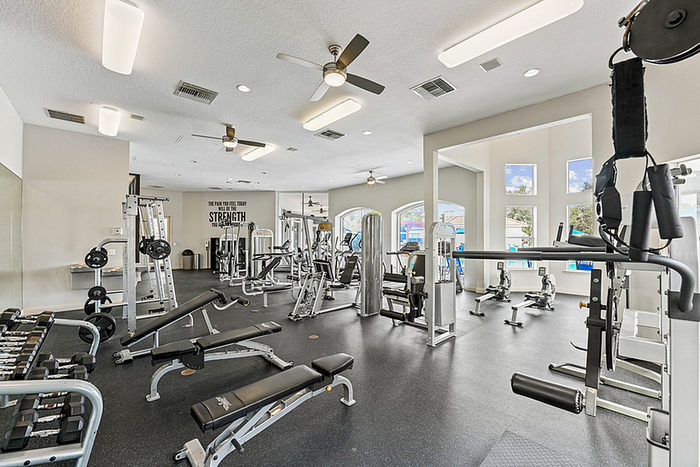 Modern fitness center with state-of-the-art equipment, featuring sleek design and ample natural light.