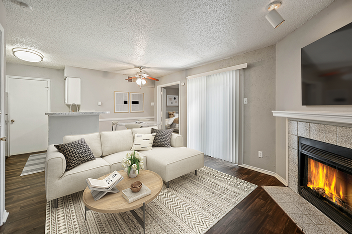 Chic open-plan living room with cozy fireplace, sleek sectional sofa, and modern decor, perfect for relaxation and style.