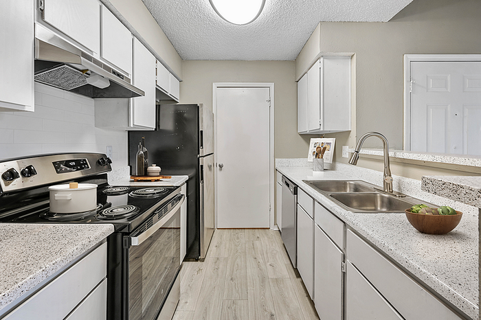 Modern kitchen featuring sleek countertops, stainless steel appliances, and ample cabinetry for storage.