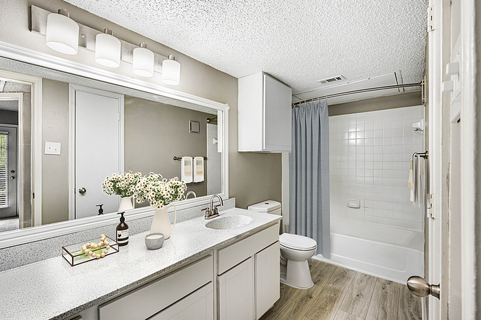 Bright and modern bathroom featuring a luxurious vanity with stylish fixtures, ample storage, and elegant decor.