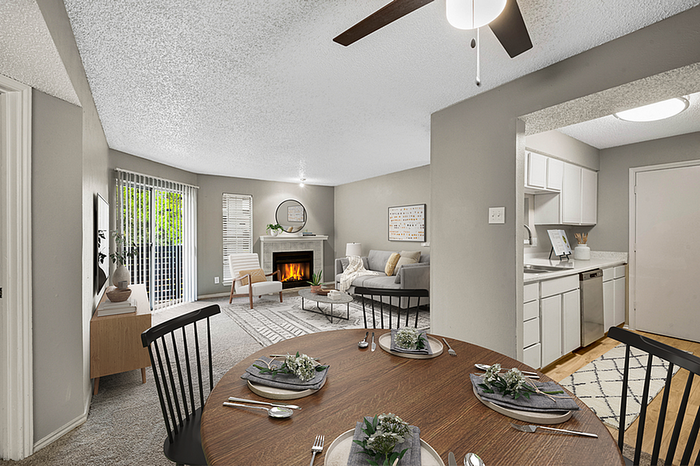Chic open-concept living space featuring a cozy fireplace, dining area, and modern kitchen perfect for entertaining.