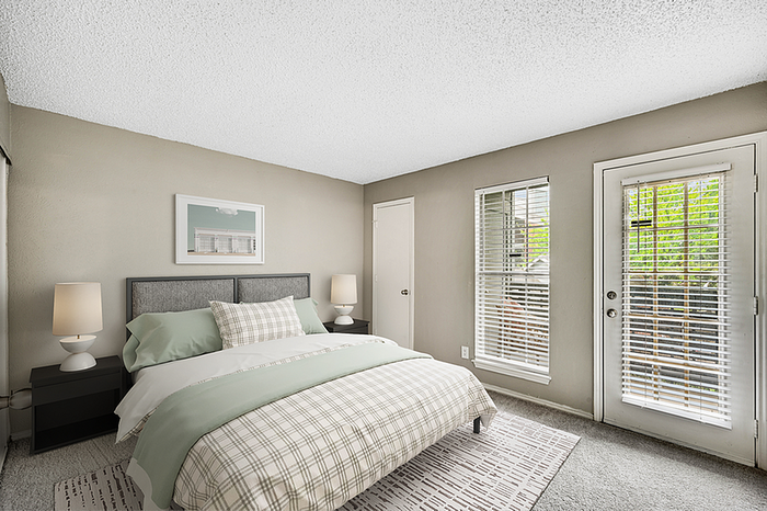 Inviting bedroom with modern decor, featuring a cozy bed, soft lighting, and large windows for natural light.