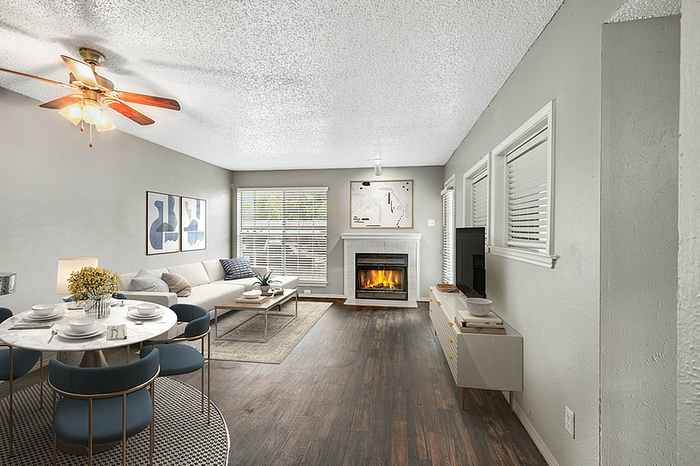 Chic living room with modern decor, cozy fireplace, and elegant dining area in an inviting open-concept layout.