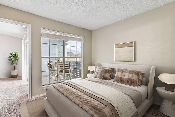 Inviting bedroom with cozy bedding and a serene balcony view, perfect for relaxation and outdoor dining.