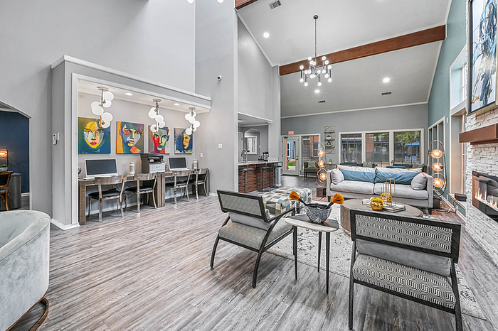 Chic and welcoming clubhouse with modern decor, cozy fireplace, and vibrant artwork, offering a blend of comfort and style.