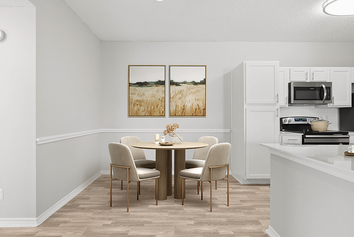Modern dining area with elegant wooden table and four stylish chairs, adjacent to a sleek kitchen with white cabinets and stainless appliances, creating a warm and inviting atmosphere.