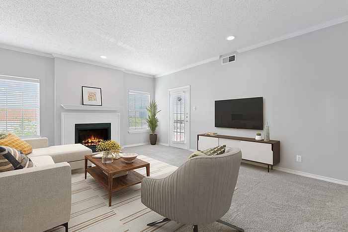 Charming living room with cozy fireplace, elegant decor, and abundant natural light streaming through large windows.