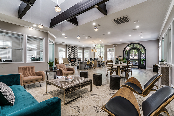 Elegant clubhouse with modern furnishings, stylish lighting, and abundant natural light, perfect for social gatherings.