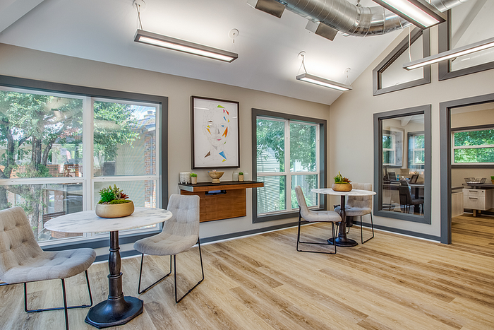 Bright and modern clubhouse space with large windows, stylish seating, and elegant lighting, ideal for social gatherings or relaxation.