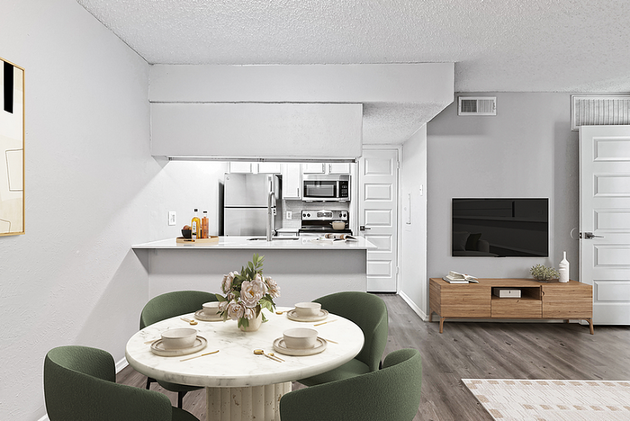 Modern open-plan apartment with sleek kitchen, elegant dining area, and cozy living room featuring stylish decor.