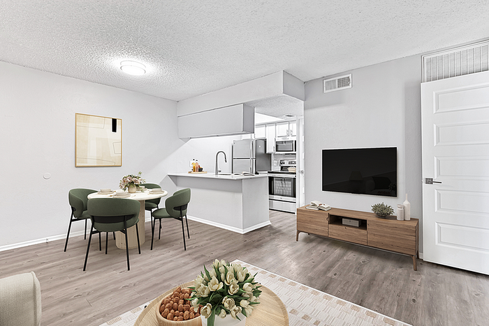 Modern open-plan living space featuring a stylish dining area, elegant kitchen, and inviting lounge with contemporary decor.