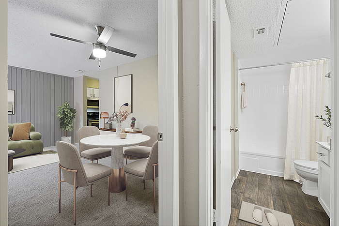 Sophisticated apartment interior showcasing a cozy dining area, stylish living room, and modern bathroom with elegant decor.