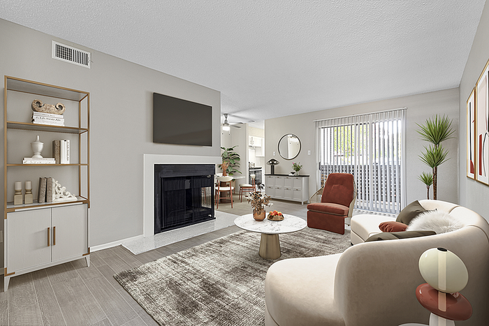 Contemporary living room with elegant furniture, stylish fireplace, and abundant natural light from large sliding doors.